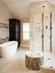 Free standing soaking tub with wet/dry bench and smart technology for the large walk-in shower by Owings Brothers Contracting.
