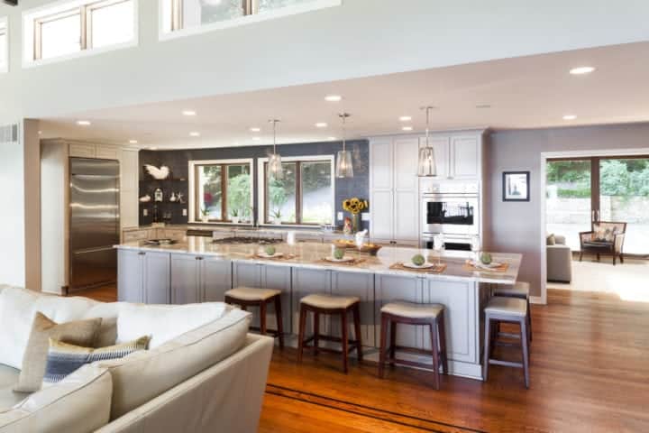 extra large island with seating for 6 and brown fantasy granite top with cooktop