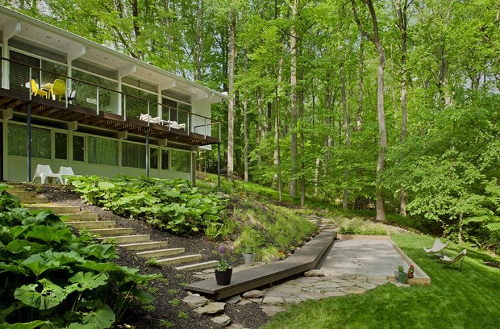 exterior of home with beautiful landscape and cable deck railing