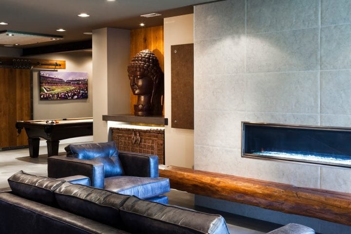 basement interior design with sculpture and modern fireplace