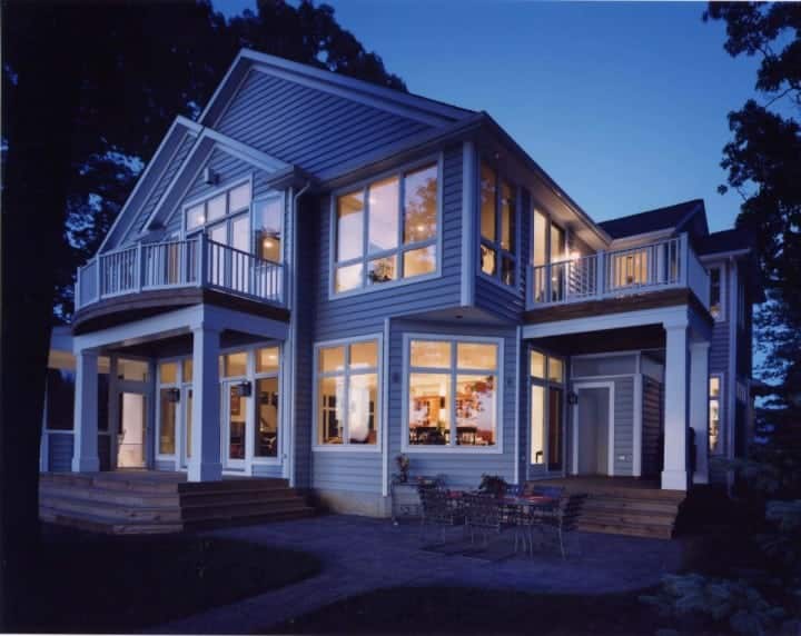 waterfront custom home with many windows