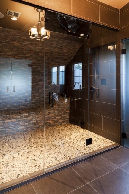 large custom steam shower with tiled bed to recline