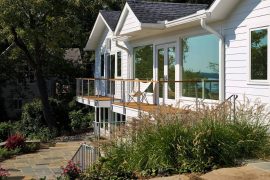 steel cable exterior rails with wood handrail and composite deck overlooking water