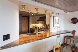 live edge countertop in contemporary condo kitchen pass through