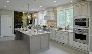 kitchen addition with beautiful exhaust hood and gold low-arc faucet