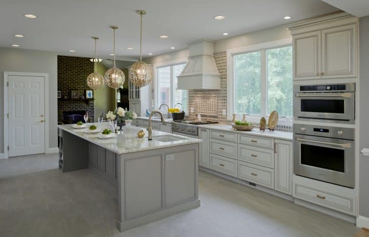 kitchen addition with beautiful exhaust hood and gold low-arc faucet