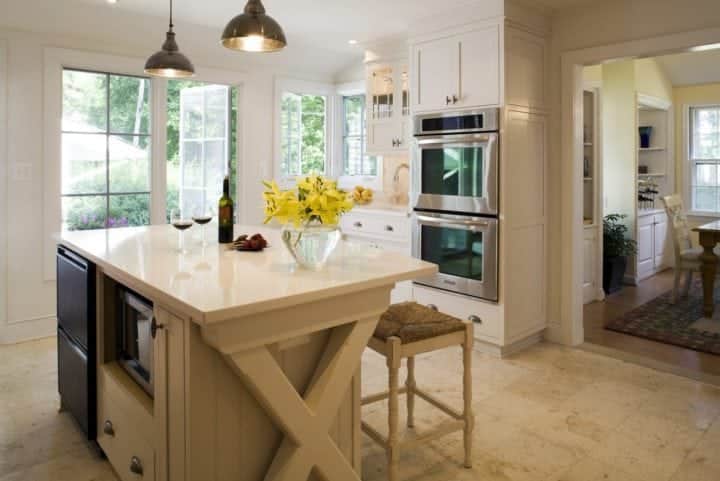 engineered stone countertop over beige custom island cabinet with microwave and beverage frig