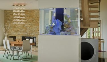 Aquarium as a divider between dining room and kitchen by Owings Brothers Contracting.