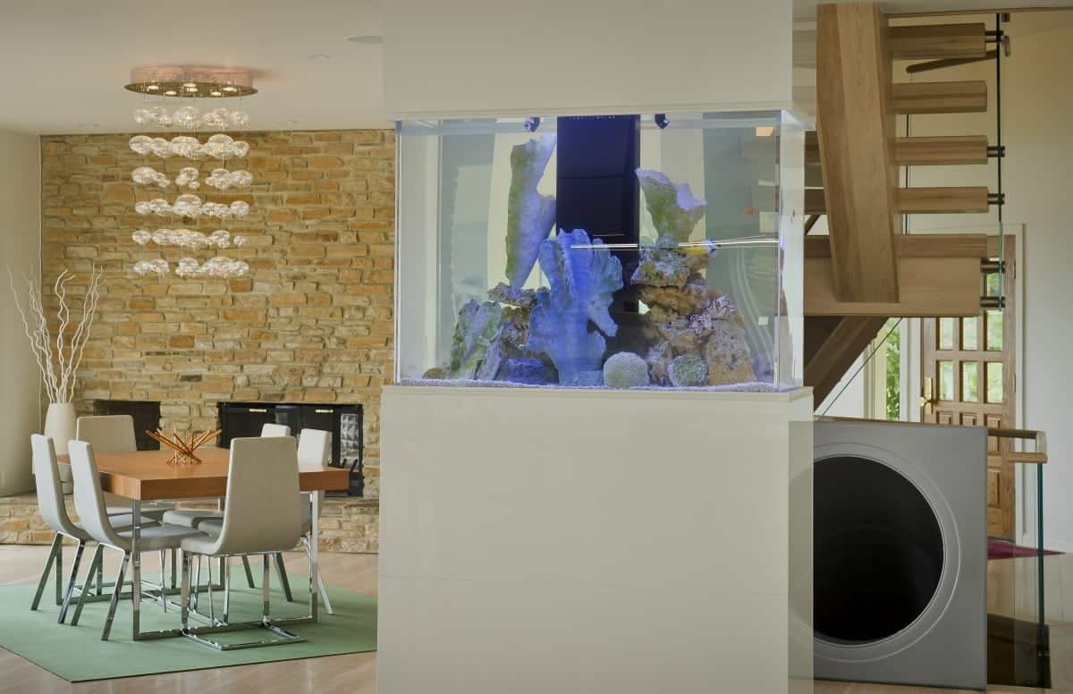 Aquarium as a divider between dining room and kitchen by Owings Brothers Contracting.