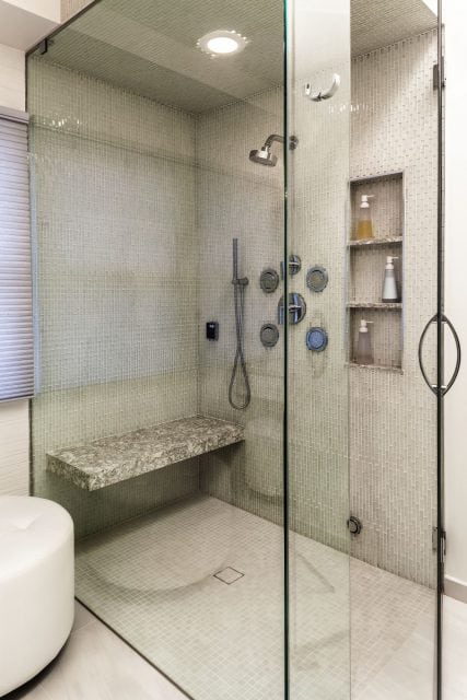 A walk-in shower, body sprays, steam unit, glass walls aid in making this contemporary master bath remodel by Owings Brothers Contracting an outstanding remodel.
