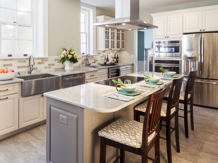 transitional kitchen with gray and cream cabinets and engineered stone counter tops with wood look ceramic flooring