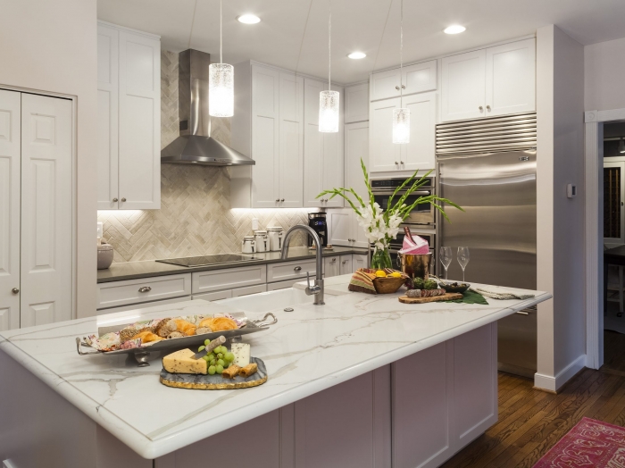 kitchen with cream painted cabinets, white granite island counter top with gray perimeter counter tops