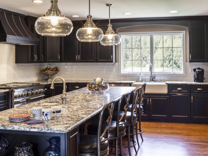 custom made black kitchen cabinets, gray and white granite tops