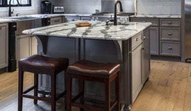 Rustic kitchen remodel with gray cabinets and Cambria countertops in Seagrove by Owings Brothers.