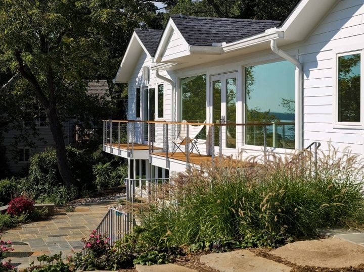 steel cable exterior rails with wood handrail and composite deck overlooking water