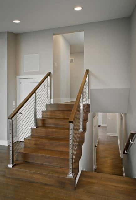 Hardwood stair and metal cable railing with personal elevator in two-story home addition by Owings Brothers Contracting.