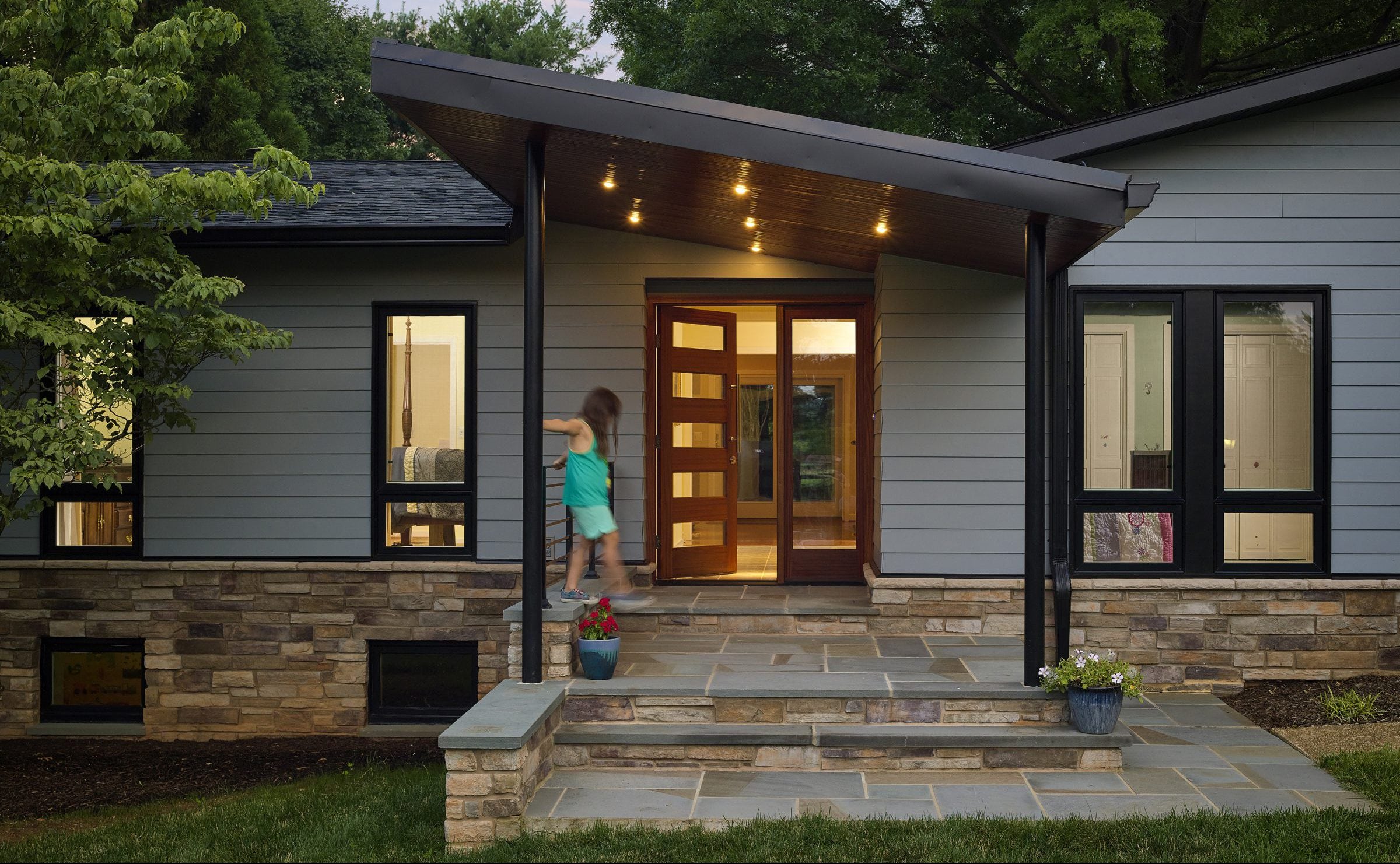 Modern front entry with slanted roof and unique 5 glass panel door and one clear glass panel sidelight