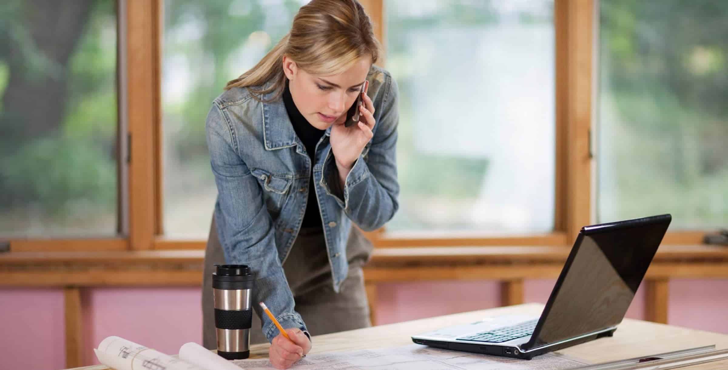woman with blueprint and phone