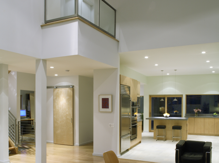 contemporary open floor plan custom built home with glass balcony and cable rails