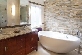 Bathroom with modern white tub and tan tile