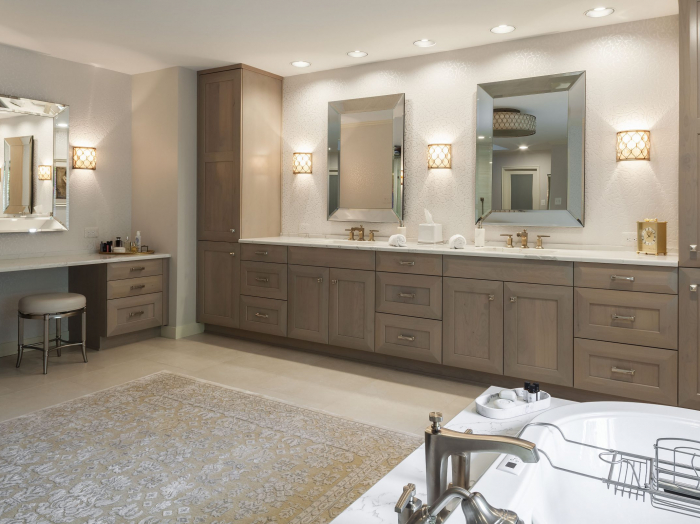 luxury bathroom with light wood cabinetry, vanity table, tile floor, flocked wallpaper, tub and walk in shower