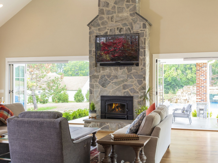 family room with folding glass walls opening to patio