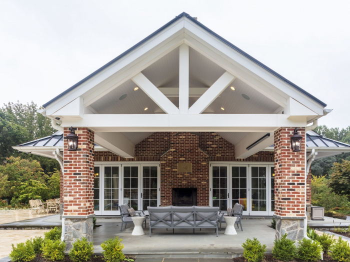 patio connected to house interior by folding glass walls