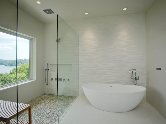Waterfront modern master bathroom with walk in shower &amp; freestanding tub, floor to ceiling tile walls