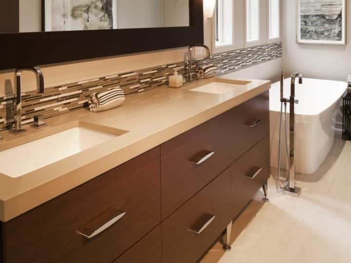 modern bathroom with mosaic tile accent strip and earth-tone colors