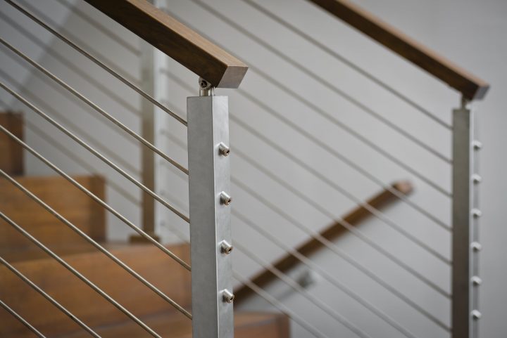 close up of interior staircase with cable railing