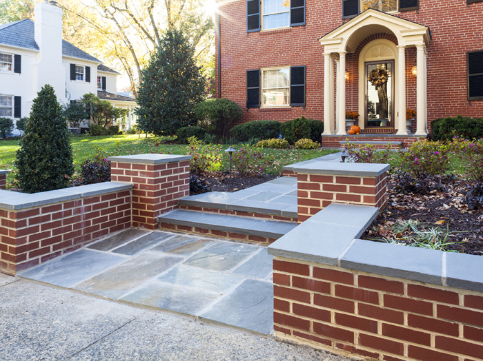 traditional door to brick home with blue stone walk