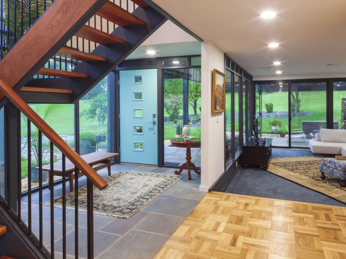 Modern front entry with 1960s look front door in turquoise with 5 small windows