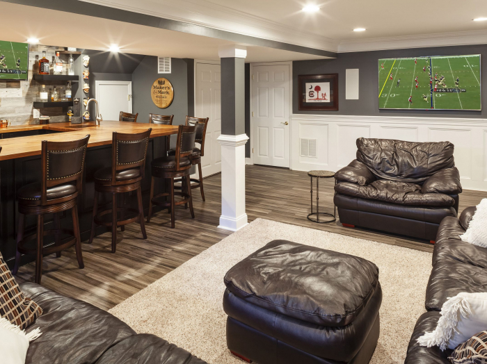 white wood paneled basement bar with paneled columns