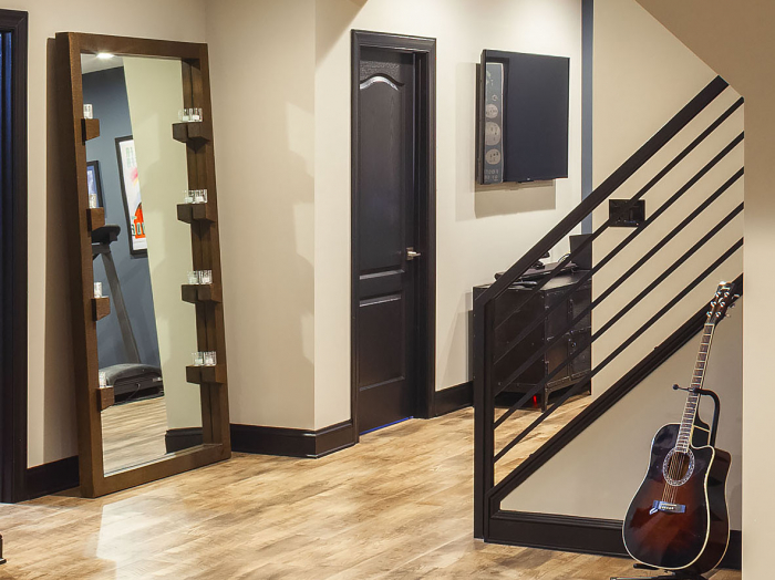 black painted base mold and door trim in industrial style basement