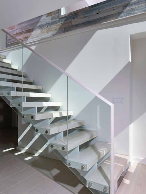 floating staircase with glass rails and stainless steel