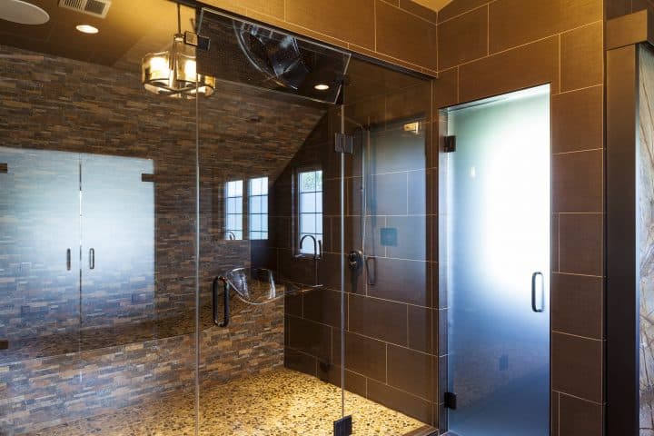 dual head steam shower with full size tile bed for lounging