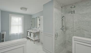 white painted wood paneled wainscotting in master bathroom