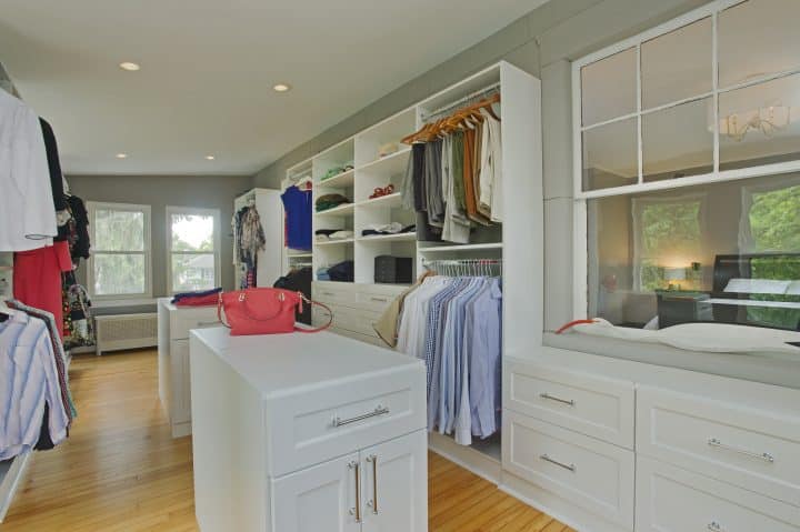 master closet with cubbies, drawers, shelves, rods and plenty of natural light Closetsandstoragebyowings