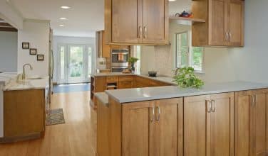 kitchen remodel with wood cabinets, wood floor and engineered stone counters