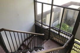 before remodel of mid century modern staircase of metal and wood