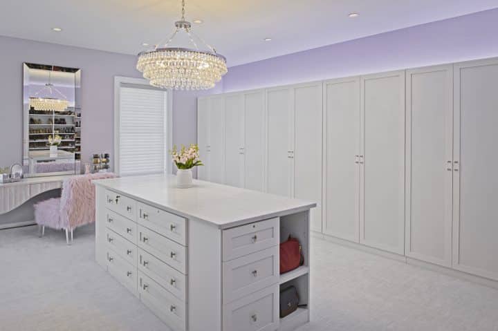 Custom walk in closet with dressing area and laundry