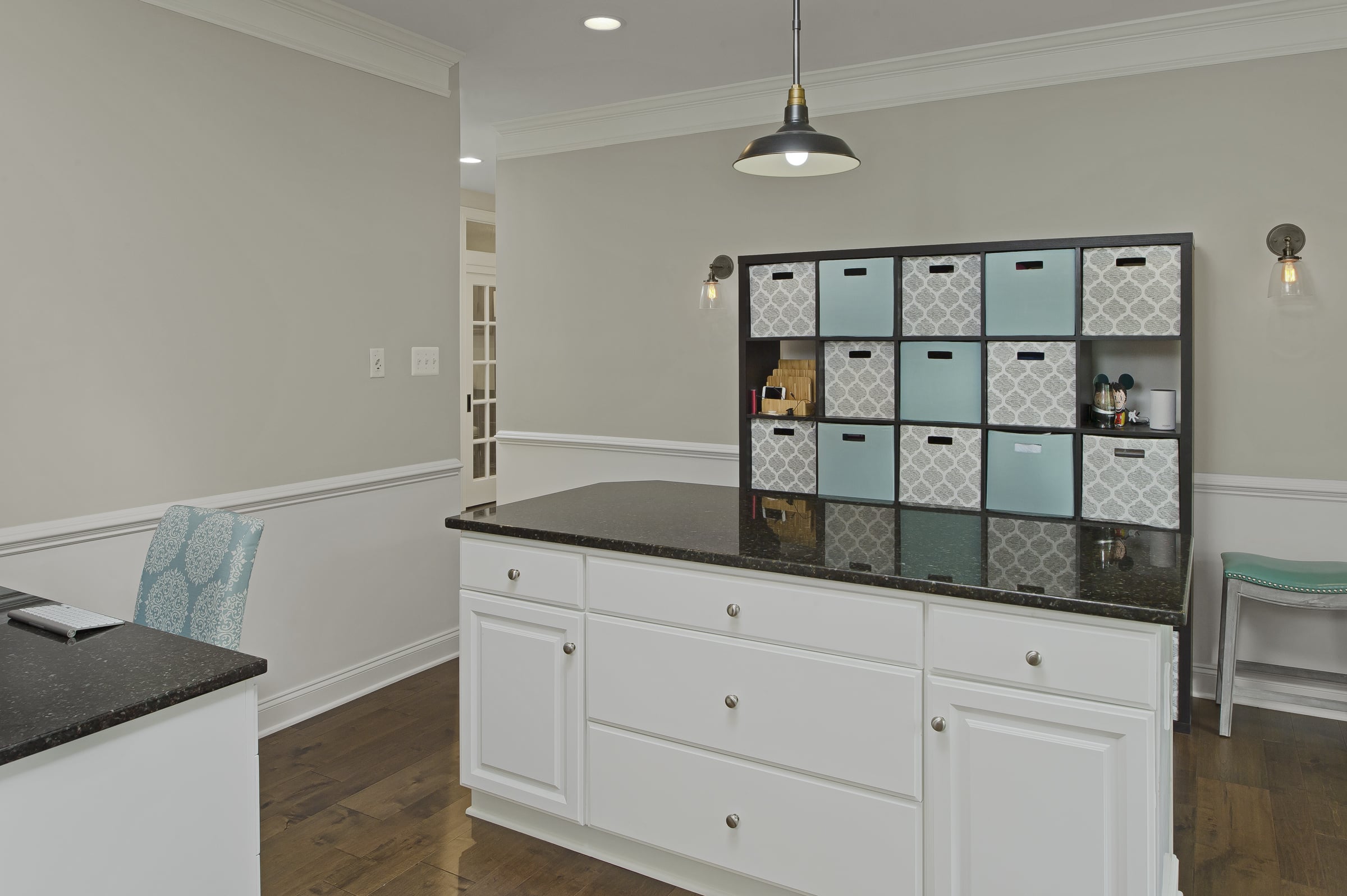 home office shared by adults and children with a large work surface and cubbies and a desk