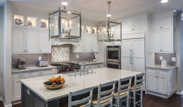 double ovens and paneled sub zero refrigerator matching the cabinets perfectly