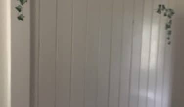 white wood paneled bathroom