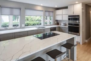 white quartz countertop and floor to ceiling white modern kitchen cabinets