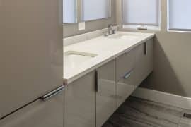 travertine-look ceramic tile bathroom floor and floating vanity