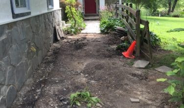 preparing ground for new stone walkway
