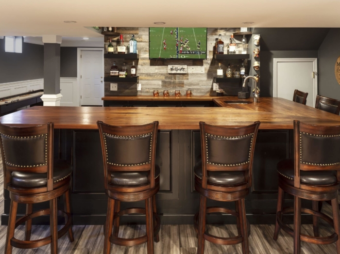 basement bar with 7 stools and tv
