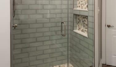 modern bathroom glass-look ceramic tile shower with pebble floor