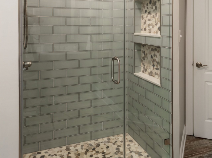 modern bathroom glass-look ceramic tile shower with pebble floor